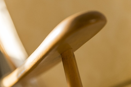 Close up shot of an armrest and peg of a vintage wooden armchairの写真素材