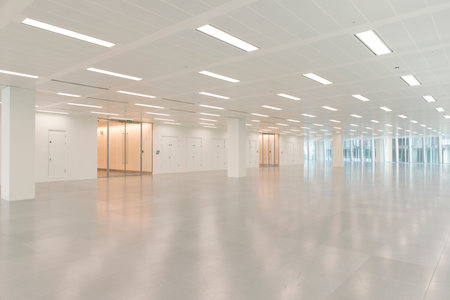 Huge empty office building interior with illuminated ceiling lights