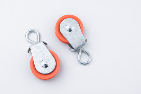 Pair of pulleys flat lay on white background with copy space