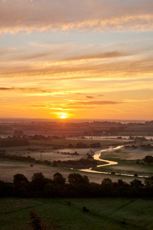 Run rising over hazy South Downs National Park