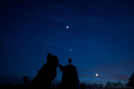 Person at telescope in blue nightの写真素材