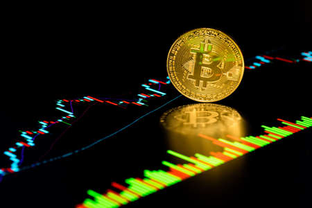 Coin with Bitcoin symbol on chart market pricesの写真素材