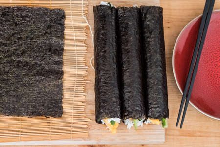 Korean gimbap aka kimbap on a red plateの写真素材