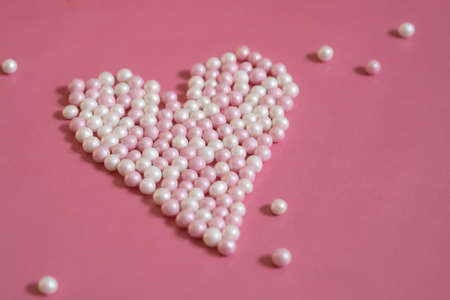 Little hearts made of pearls on a pink background. Greetings for Mother's Day. Love greetings for Valentine's Day. Space for text.の写真素材