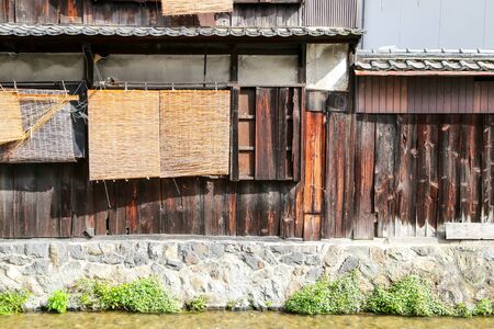 Traditional Japanese wooden house exterior with water channelの写真素材