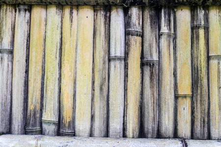 Dry bamboo fence patterned background with vertical bamboo sticksの写真素材