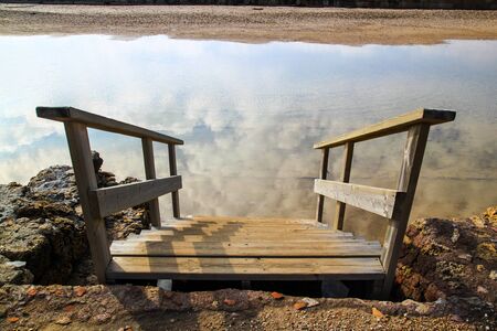 Stairway goes up down into clouds reflection.の写真素材