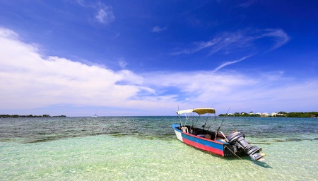 Boat in an ocean close to the beach.の写真素材