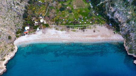 A beautiful, panoramic shot taken by a drone that captures butterfly valley. This scenery's vivid colors, its sea and its forest full of green trees create a marvelous view that is pleasing to eye.の写真素材