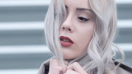 Cold portrait of young blonde with red lips
