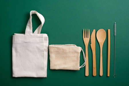 Zero waste, plastic free, eco friendly bamboo cutlery set and reusable canvas shopper bags. Sustainable lifestyle concept.の写真素材