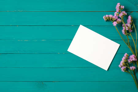 Card with flowers on green wooden backgroundの写真素材