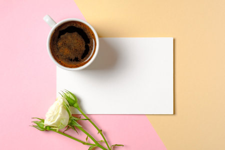 Blank paper card with copy space, cup of coffee and white roses flowers on colorful background....
