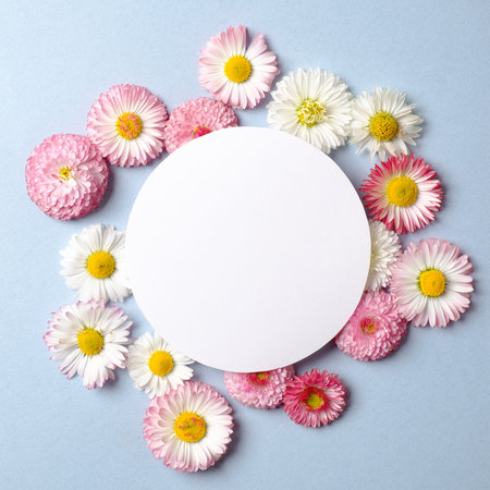 Spring holiday concept. Creative layout made of colorful flowers and blank circle-shaped paper card...