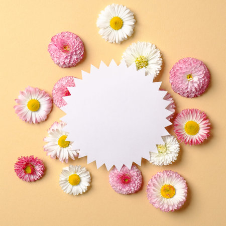 Spring holiday concept. Creative layout made of colorful flowers and blank gear wheel shaped paper...
