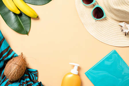 Frame made of summer woman accessories and fruits on yellow background with free space for text. Travel vacation concept. Summer background. Beach frame set. Flat lay style composition, top view.の写真素材