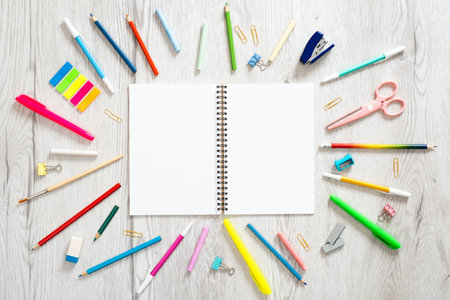 Back to school concept, creative layout with various school supplies and blank paper notepad with...