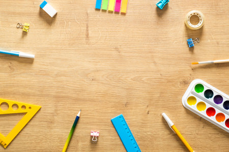 School stationery frame on wooden background. Back to school concept. Flat lay style composition,...