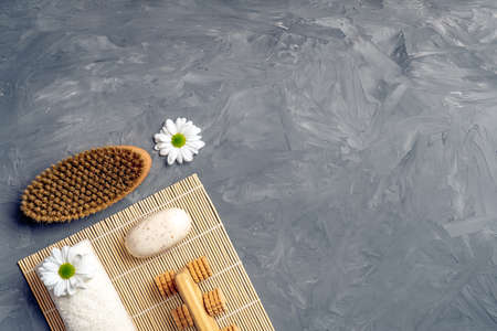 Anti cellulite massage accessories and spa beauty cosmetic products on gray stone background from above. Flat lay, top view, overhead, copy space for your text.の写真素材