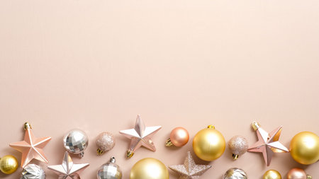 Top view stylish Christmas decorations on ivory background. Flat lay golden, silver and pink Xmas...