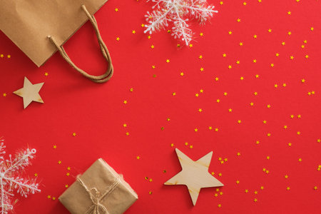 Christmas sale banner mockup. Flat lay Xmas decorations on red festive background with copy space....