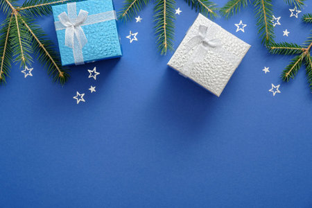 Christmas composition. Flat lay fir tree branches, Christmas presents in gift boxes and bright star...