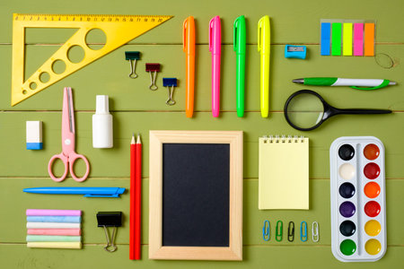 Set of school supplies on wooden table background, creative layout made of stationery. Education,...