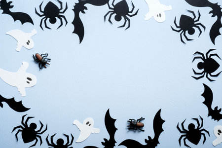 Happy halloween holiday concept. Halloween decorations, spiders, bats, ghost on blue background....