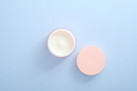 Moisturizing care skincare face cream in an open jar. Flat lay, top view, overhead. Skin care,...