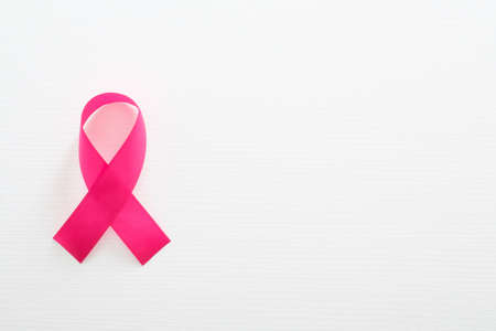 Breast cancer awareness symbol pink ribbon isolated on white with copy space. Healthcare and medicine concept.の写真素材