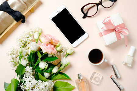 Flat lay beauty blogger workspace, top view feminine desk table with bouquet of rose flowers,...