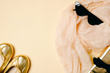 Female accessories set on beige background, woman workplace. Scarf, sunglasses, golden summer...