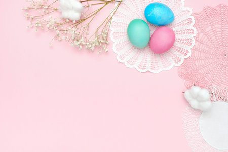 Easter eggs and napkins on pastel pink background. Top view, flat lay, Easter holiday concept,...