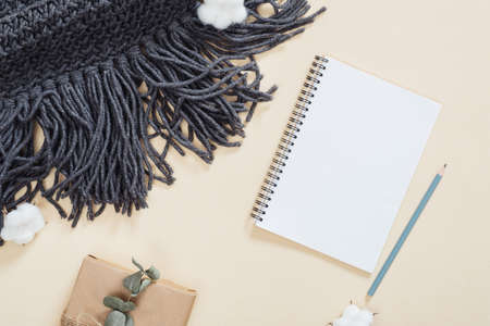 Autumn composition. Flatlay knitted scarf, paper notepad, cotton, gift box on pastel beige background. Flat lay, top view, copy space. Autumn, fall concept. above, art, autumn, background, beauty, blog, blogger, composition, concept, cotton, cozy, deの写真素材