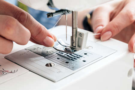 Tailor tears off the label at workshopの写真素材