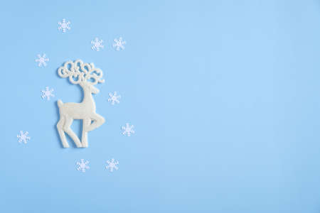 Christmas reindeer and snowflakes on blue background. Flat lay, top view. Winter holidays greeting card mockup.の写真素材