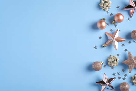 Christmas decorations, stars, balls, confetti on blue background. Xmas greeting card mockup, banner template with copy space.の写真素材