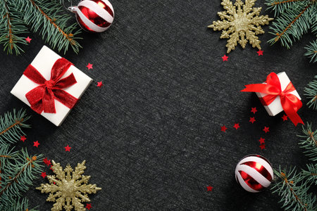 Black Christmas background with gift boxes, golden snowflakes, balls, confetti. Elegant Xmas...