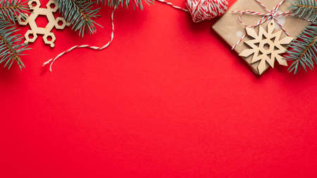 Vintage Christmas frame top border made of gift box wrapped craft paper, Christmas tree branches and wooden decorations. Flat lay, top view.の写真素材