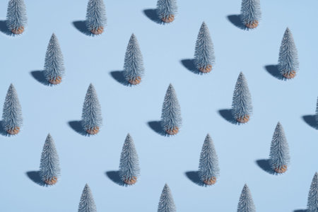 Pattern of silver Christmas trees on pastel blue background. Minimal style. Christmas or New Year...