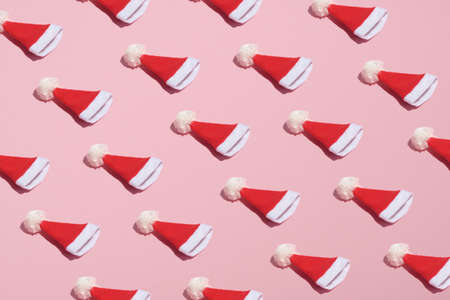 Santa hat pattern on pink background. Christmas, winter holidays, New year concept. Minimal style.の写真素材