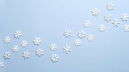 White wooden snowflakes on blue background. Christmas, New Year, winter holidays pattern.の写真素材