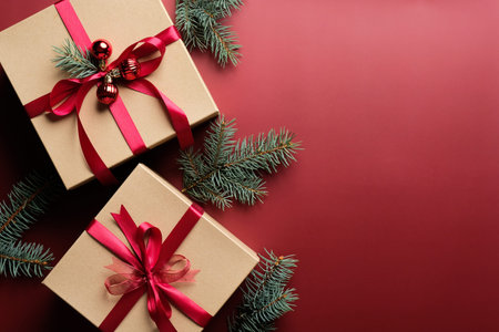 Elegant Christmas background with kraft paper Christmas gift boxes and fir branches. Flat lay, top...