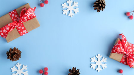 Christmas composition. Frame made of handmade gift boxes, wooden snowflakes, pine cones, red berries...