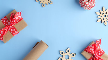 Blue Christmas background with gift boxes, wooden snowflakes, wrapping paper. Christmas, winter...