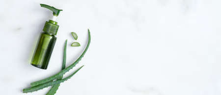 Aloe vera gel and sliced plant leaves on marble background. Natural organic SPA cosmetic product. Flat lay, top view.の写真素材