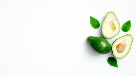 Fresh ripe avocado with green leaves isolated on white background. Top view with copy space.