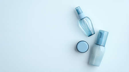 Hyaluronic acid collagen cosmetics packages on blue background. SPA natural organic water based beauty products set. Flat lay, top view.の写真素材