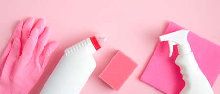 Cleaning service banner mockup. Flat lay house cleaning supplies on pink background. Top view cleaner spray bottle, rag, sponge, detergent, rubber gloves. Housecleaning and housekeeping conceptの写真素材