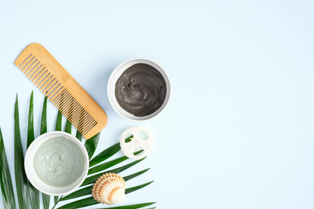 Natural organic SPA cosmetic products for hair. Homemade hair mask in bowls and hair comb. Top view,...